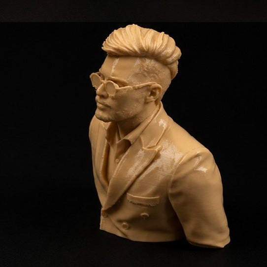 Bust sculpture of a person wearing glasses and a suit on a black background